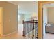 Upstairs hallway with wood and wrought iron railings at 8426 Morehouse Dr, Orlando, FL 32836