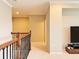 Upstairs hallway with wood and wrought iron railings at 8426 Morehouse Dr, Orlando, FL 32836