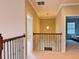 Upstairs hallway with wood and wrought iron railings and a light fixture at 8426 Morehouse Dr, Orlando, FL 32836