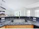 Kitchen island with granite countertop, stainless steel sink, and wood cabinets at 790 Silhouette Ct, Longwood, FL 32750