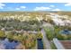 Aerial view showcasing the home's position near water and other houses at 790 Silhouette Ct, Longwood, FL 32750