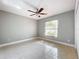 Bright bedroom with ceiling fan, window, and tile flooring at 790 Silhouette Ct, Longwood, FL 32750