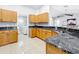 Modern kitchen with granite countertops, stainless steel appliances, and wood cabinets at 790 Silhouette Ct, Longwood, FL 32750