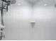 Clean shower with white tile and shower caddy at 790 Silhouette Ct, Longwood, FL 32750