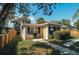 Charming bungalow with a yellow door and well-maintained landscaping at 315 E St, Lake Wales, FL 33853