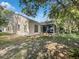 Back of house with screened porch and grassy yard at 101 Candlewick Ct, Sanford, FL 32771