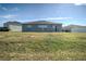 Rear view of a single-story house with a large backyard at 168 Taft Dr, Davenport, FL 33837
