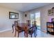 Bright dining room with hardwood table and access to backyard at 168 Taft Dr, Davenport, FL 33837