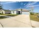 One-story home with gray exterior, attached garage, and manicured lawn at 168 Taft Dr, Davenport, FL 33837