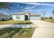 One-story home with gray exterior, attached garage, and manicured lawn at 168 Taft Dr, Davenport, FL 33837