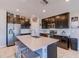 Modern kitchen with island, dark cabinets, and stainless steel appliances at 168 Taft Dr, Davenport, FL 33837