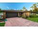 Dark brown garage door and a pink driveway at 1159 Collins Ave, Orange City, FL 32763