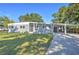 Charming mid-century modern home with a carport and manicured lawn at 106 Orange Dr, Sanford, FL 32773