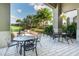 Covered patio with multiple tables and chairs for outdoor dining at 2071 Limestone Trl, Kissimmee, FL 34747