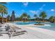 Relaxing pool area with lounge chairs and umbrellas at 2071 Limestone Trl, Kissimmee, FL 34747