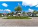 Community clubhouse with palm trees and a paved courtyard at 2071 Limestone Trl, Kissimmee, FL 34747