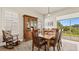 Bright dining room with wooden table and chairs, hardwood floors and view to patio at 2071 Limestone Trl, Kissimmee, FL 34747