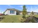 House exterior showcasing a covered patio and landscaped yard at 2071 Limestone Trl, Kissimmee, FL 34747