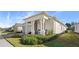 Single story home with light-colored exterior, covered porch, and landscaping at 2071 Limestone Trl, Kissimmee, FL 34747