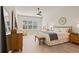 Main bedroom with king-size bed, large windows and wood dresser at 2071 Limestone Trl, Kissimmee, FL 34747