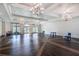 Spacious community room with hardwood floors and elegant chandelier at 2071 Limestone Trl, Kissimmee, FL 34747