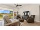Spacious living room with leather sofas, large TV, and sliding glass doors leading to backyard at 2071 Limestone Trl, Kissimmee, FL 34747