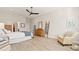 Bright main bedroom with king bed, wood furniture, and an accent chair at 2071 Limestone Trl, Kissimmee, FL 34747