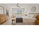 Main bedroom with king bed, wood furniture, and a relaxing sitting area at 2071 Limestone Trl, Kissimmee, FL 34747