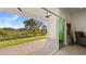 Spacious patio with sliding glass doors, overlooking a tranquil landscape at 2071 Limestone Trl, Kissimmee, FL 34747