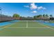 Tennis court with net and blue and green surface at 2071 Limestone Trl, Kissimmee, FL 34747