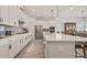 Modern kitchen with white shaker cabinets, quartz countertops and island, stainless steel appliances at 2071 Limestone Trl, Kissimmee, FL 34747