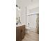 Bright bathroom featuring a tub, shower, and wood-look floors at 2071 Limestone Trl, Kissimmee, FL 34747