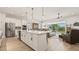 Open concept kitchen with island, stainless steel appliances and view into the living room at 2071 Limestone Trl, Kissimmee, FL 34747