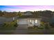 Single-story house with light-colored exterior, covered porch, and landscaping at 2071 Limestone Trl, Kissimmee, FL 34747