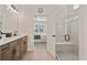 Modern bathroom with double vanity, large shower, and view of bedroom at 2071 Limestone Trl, Kissimmee, FL 34747