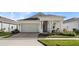 Single-story house with light-colored exterior, covered porch, and landscaping at 2071 Limestone Trl, Kissimmee, FL 34747