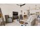 Open concept living room with leather furniture, a large TV and kitchen views at 2071 Limestone Trl, Kissimmee, FL 34747