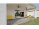 Relaxing covered patio with yellow chairs and ceiling fans at 2071 Limestone Trl, Kissimmee, FL 34747