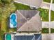 House with a screened pool, seen from above at 1055 Lake Berkley Dr, Kissimmee, FL 34746