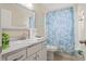 Bathroom with sink, toilet and teal shower curtain at 1055 Lake Berkley Dr, Kissimmee, FL 34746