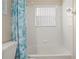 Bathroom with shower/tub combo and teal shower curtain at 1055 Lake Berkley Dr, Kissimmee, FL 34746