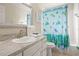 Clean bathroom with shower/tub combo, white vanity, and sea-themed decor at 1055 Lake Berkley Dr, Kissimmee, FL 34746