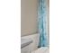 Toilet and shower with tropical-themed shower curtain at 1055 Lake Berkley Dr, Kissimmee, FL 34746