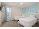 Two twin beds, a TV, and light blue accent wall at 1055 Lake Berkley Dr, Kissimmee, FL 34746