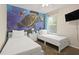 Two twin beds, a mural, and a TV in a well-lit bedroom at 1055 Lake Berkley Dr, Kissimmee, FL 34746