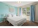 Bright bedroom with a queen-size bed and large window at 1055 Lake Berkley Dr, Kissimmee, FL 34746