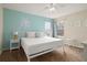 King-size bed, nightstands and a teal accent wall in a spacious bedroom at 1055 Lake Berkley Dr, Kissimmee, FL 34746