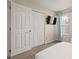 Bedroom with double closet and wall mounted TV at 1055 Lake Berkley Dr, Kissimmee, FL 34746