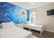 Bedroom with twin beds, mermaid mural, and flat-screen TV at 1055 Lake Berkley Dr, Kissimmee, FL 34746