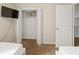 Bedroom with twin beds, closet, and flat-screen TV at 1055 Lake Berkley Dr, Kissimmee, FL 34746